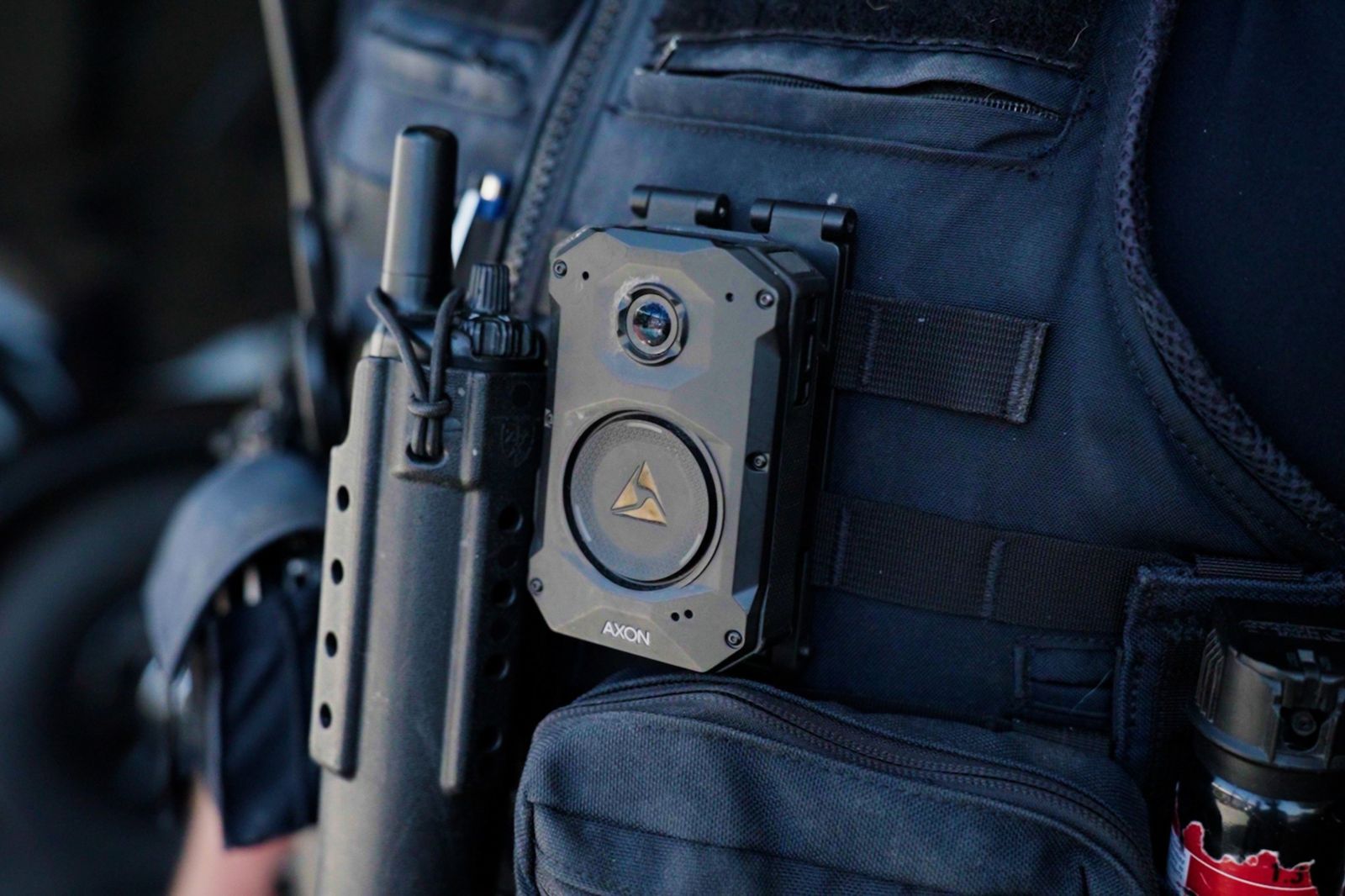 A close-up shot of a police officer wearing an Axon body camera by Martens Coyotes via Shutterstock