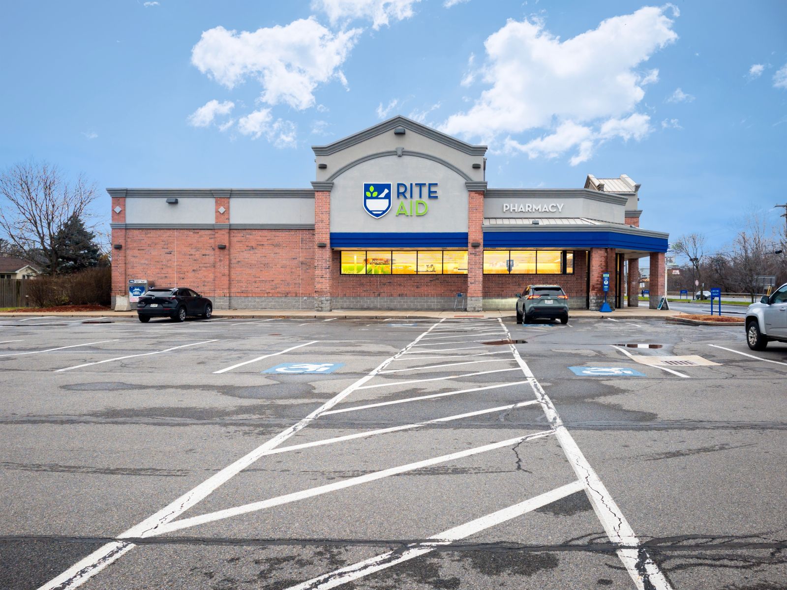 A shot of a Rite Aid location across a parking lot by Mahmoud Suhail via Shutterstock