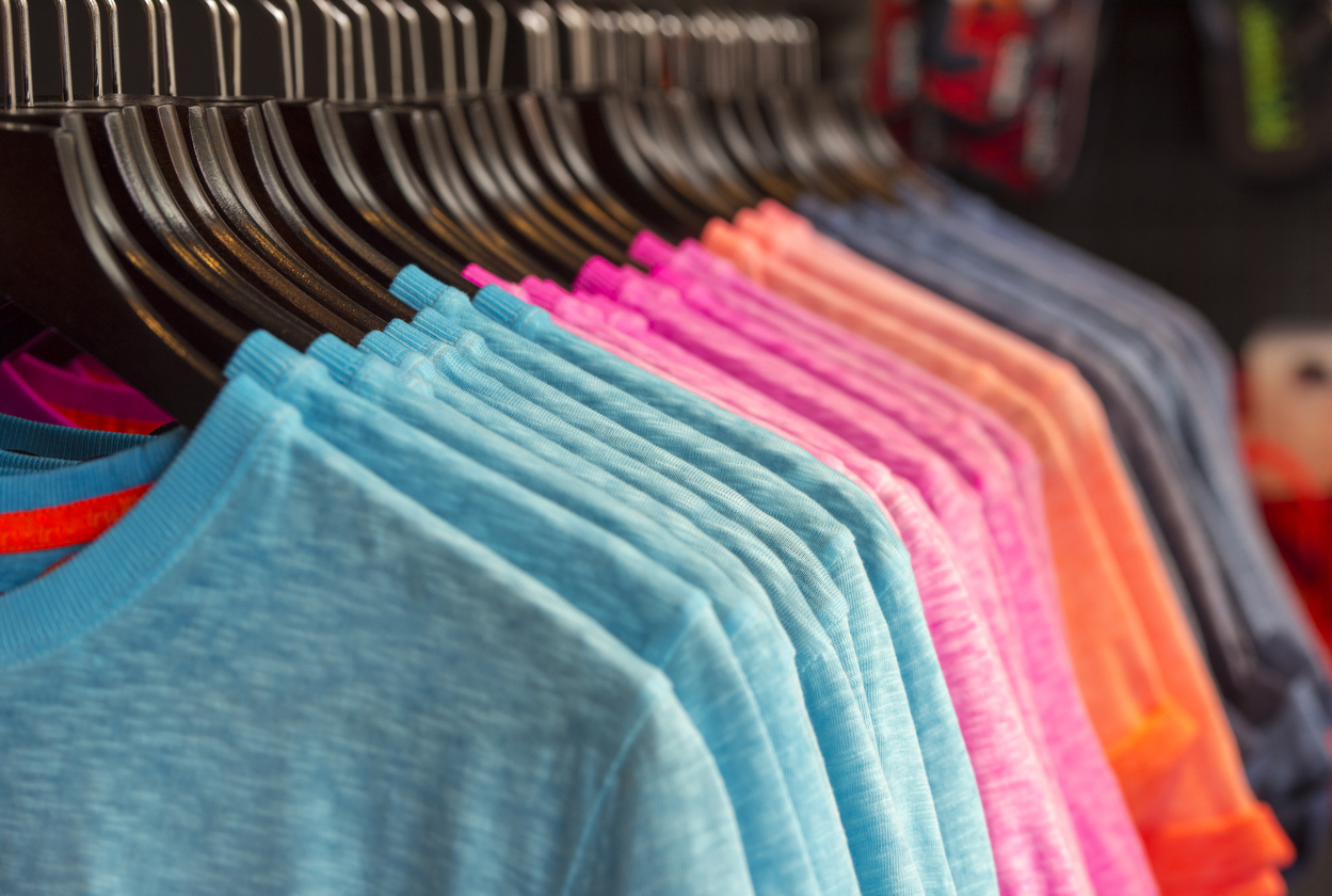 Consumer Products - Row of colored t shirts in a store by AlxeyPnferov via iStock