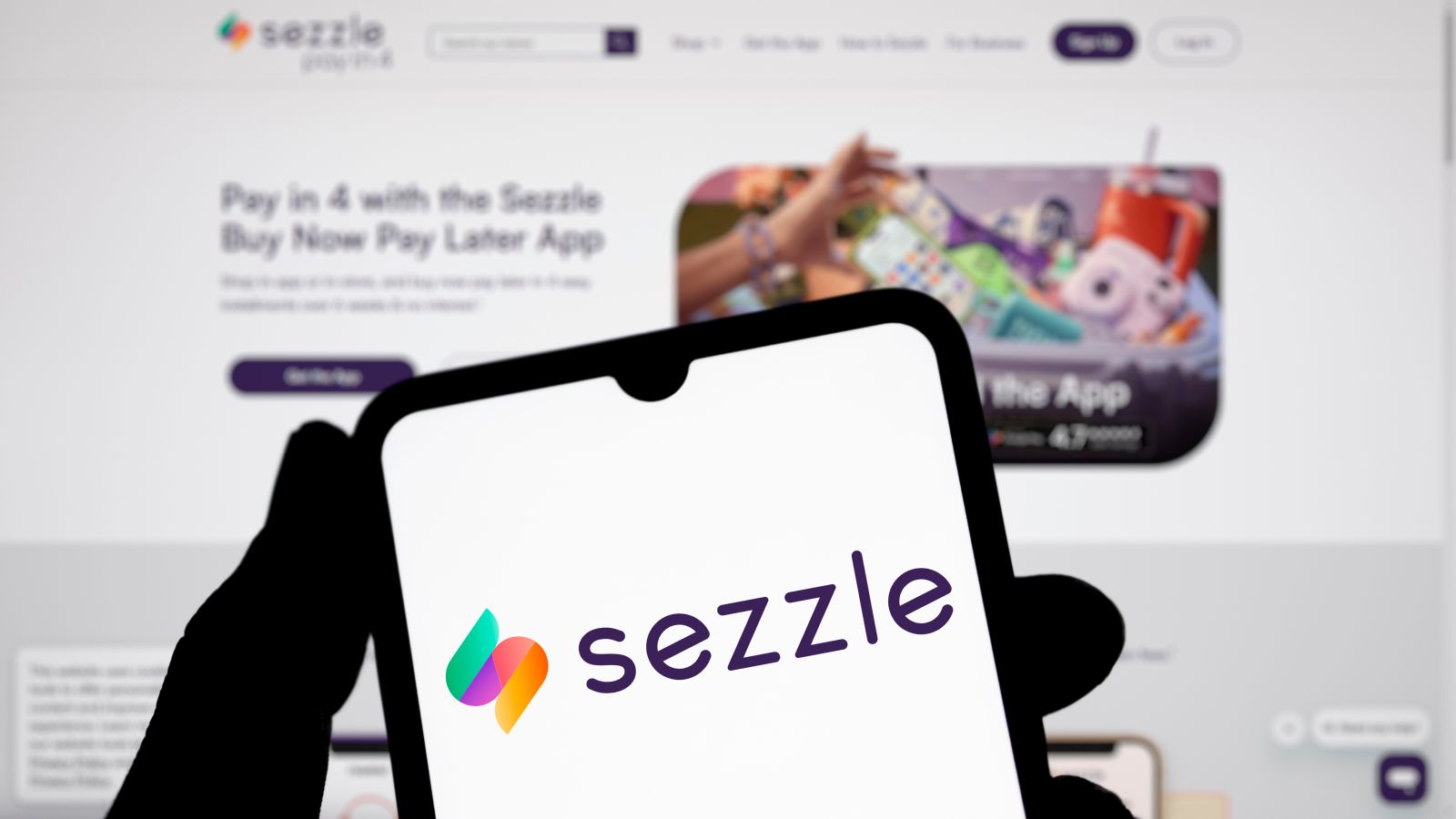 The Sezzle website displayed on a phone and a website by Mojahid Mottakin via Adobe Stock