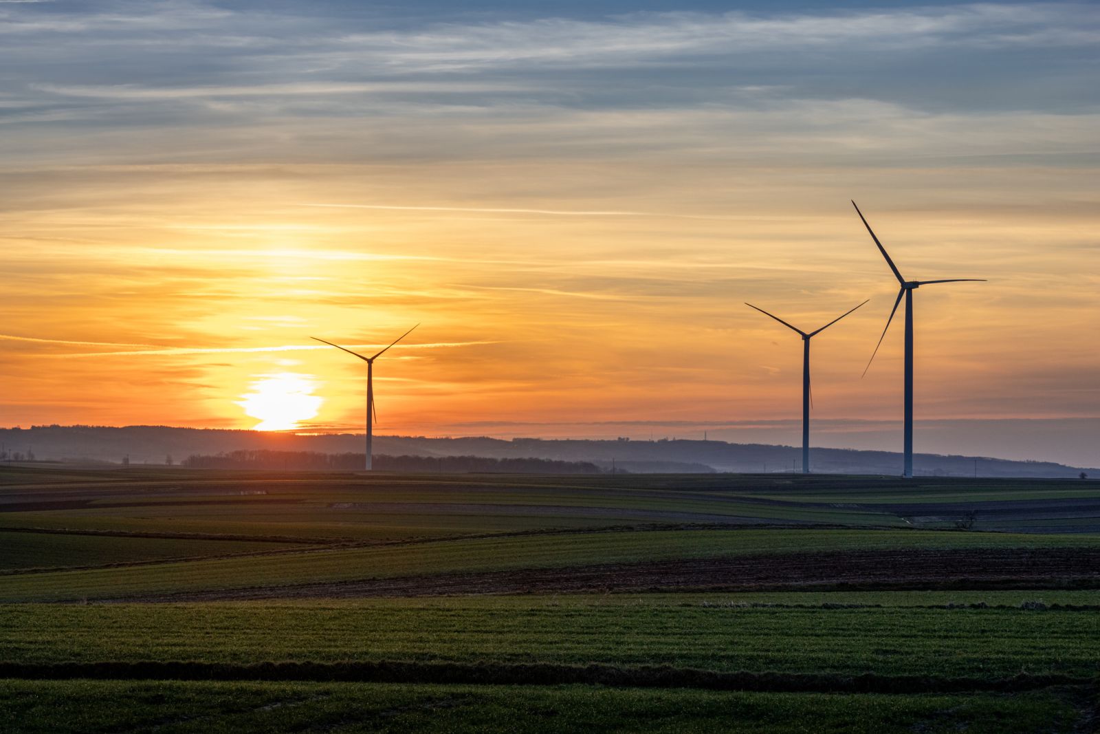 Green Energy (EV, solar, etc.) - Wind mills wind turbines sunset by Artur Kud via iStock