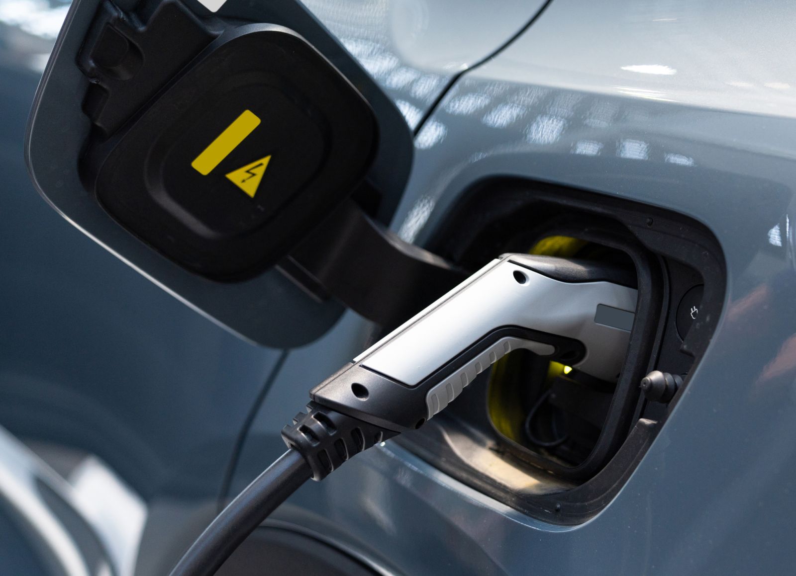 closeup of electric car charging by Scharfsinn86 via iStock