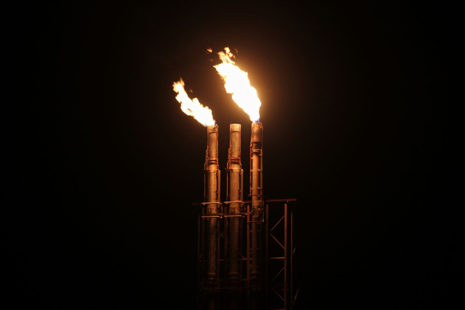 Natural Gas - Triple natural gas flare burning at night by Kirsten Strickland via iStock