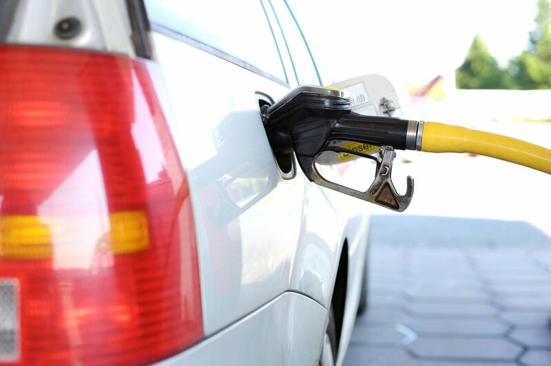 Oil - A car being refueled at a gas station