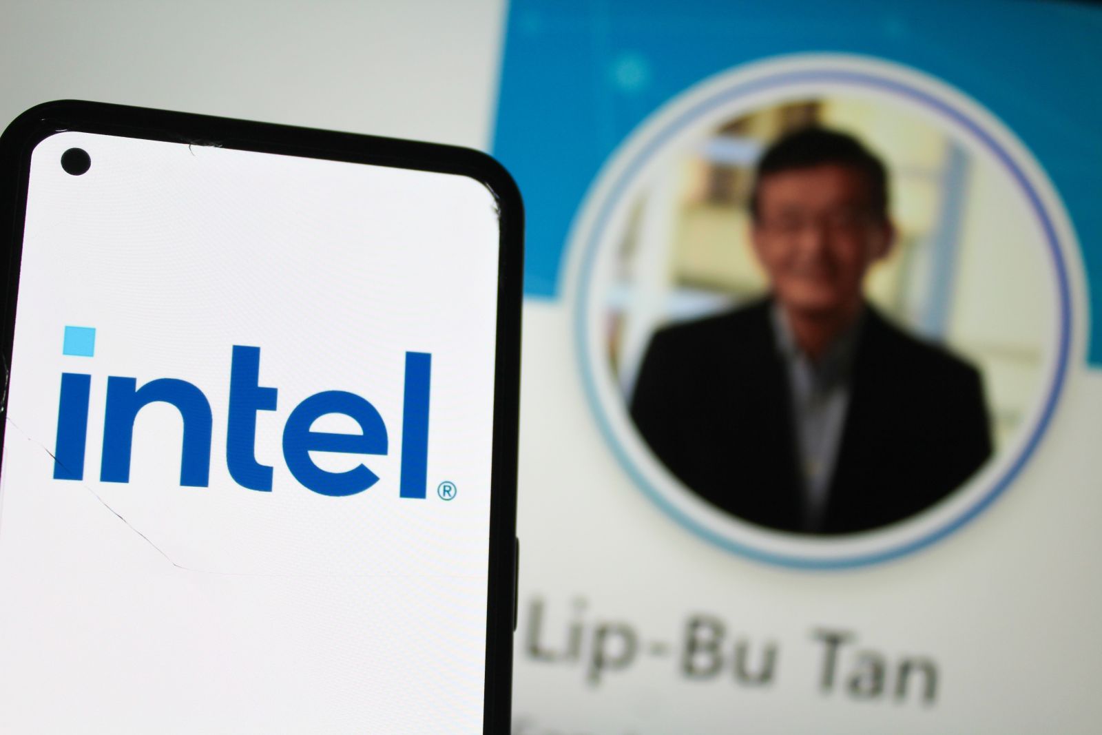 The Intel logo in front of the LinkedIn profile for CEO Lip-Bu Tan by Ahyan Stock Studios via Shutterstock
