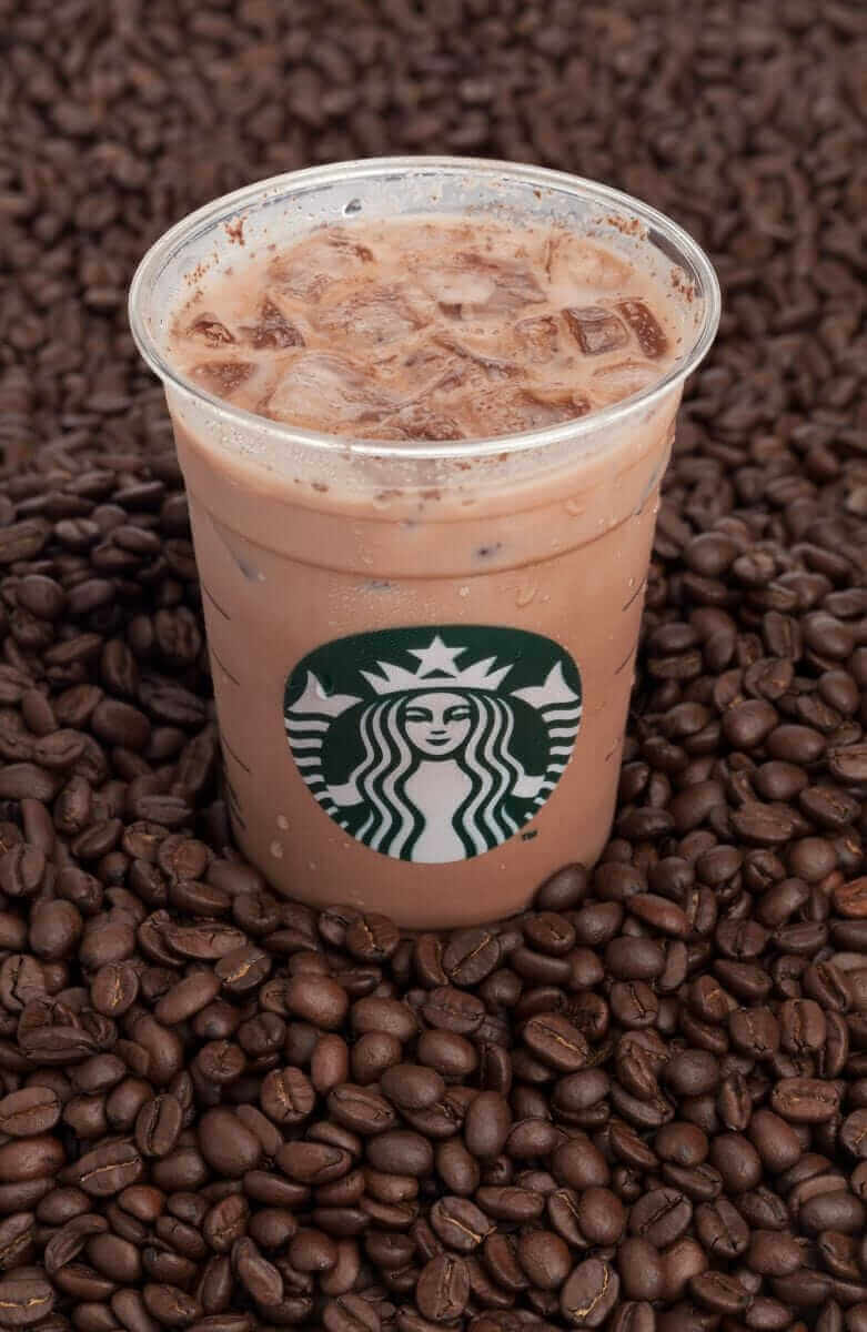 Starbucks ice coffee on bed of coffee beans by Robtek via iStock