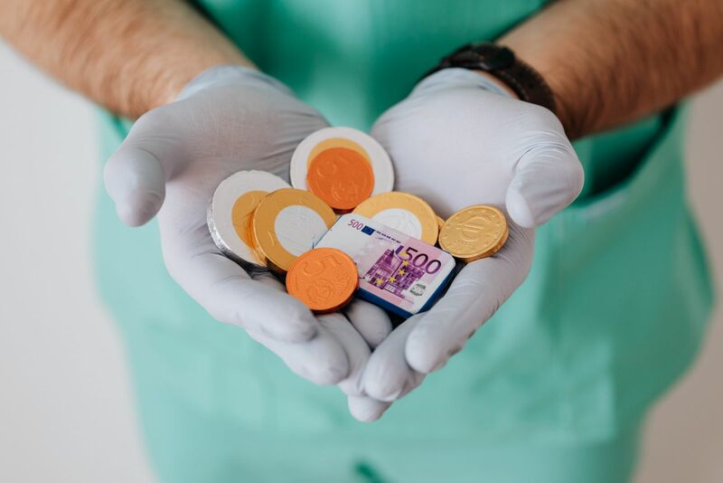 Healthcare - doctor holding fake money