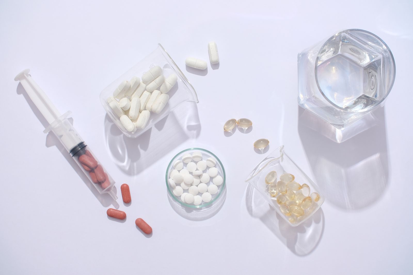 Healthcare - pills in a petri dish and syringe by LightStock via iStock