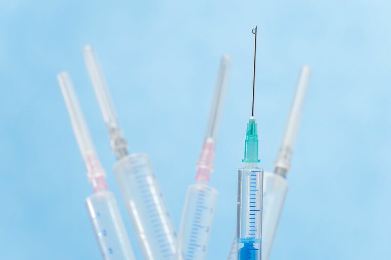 Healthcare - transparent-syringe-with-liquid-drop-falling-from-needle-SBI-300904623