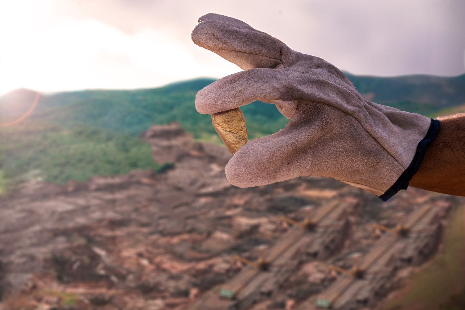 Gold - Chunk of gold in a gloved hand by RHJPhotoandilust___ via Shutterstock