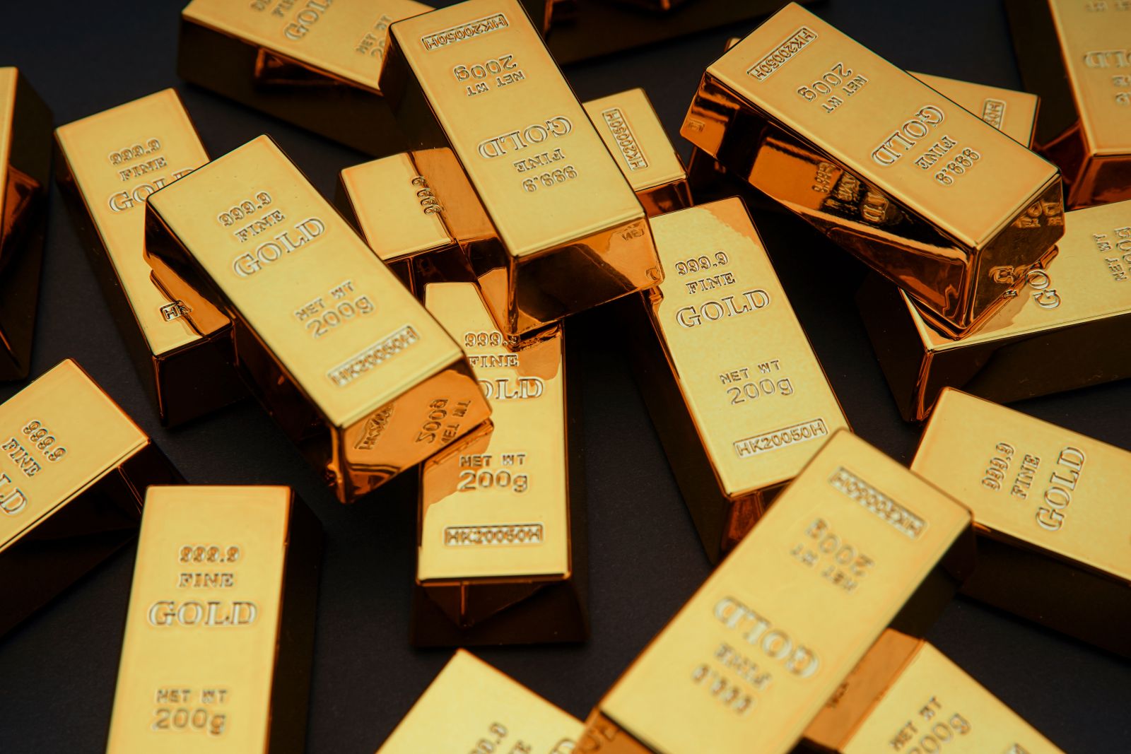 Scattered gold bars on black table by Varga_photography via Adobe Stock
