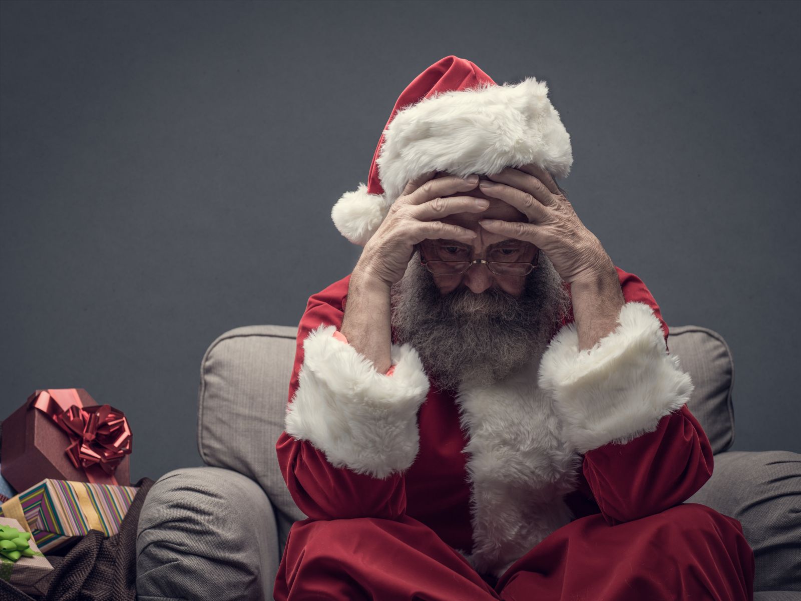 A concept image showing Santa Claus with his head in his hands by Stokkete via Shutterstock