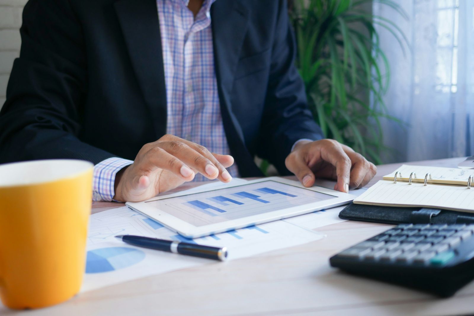 Businessman looking at charts by Towfiqu barbhuiya via Unsplash