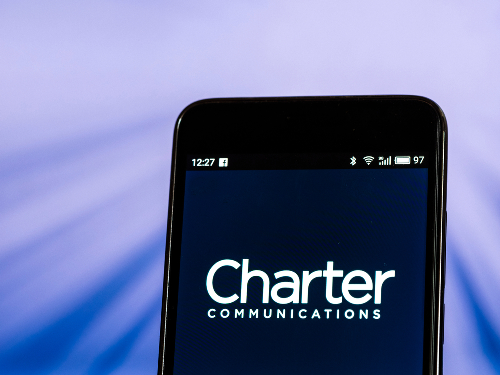 Communication Services - Charter Communications Inc_ phone with blue background by- IgorGolovniov via Shutterstock