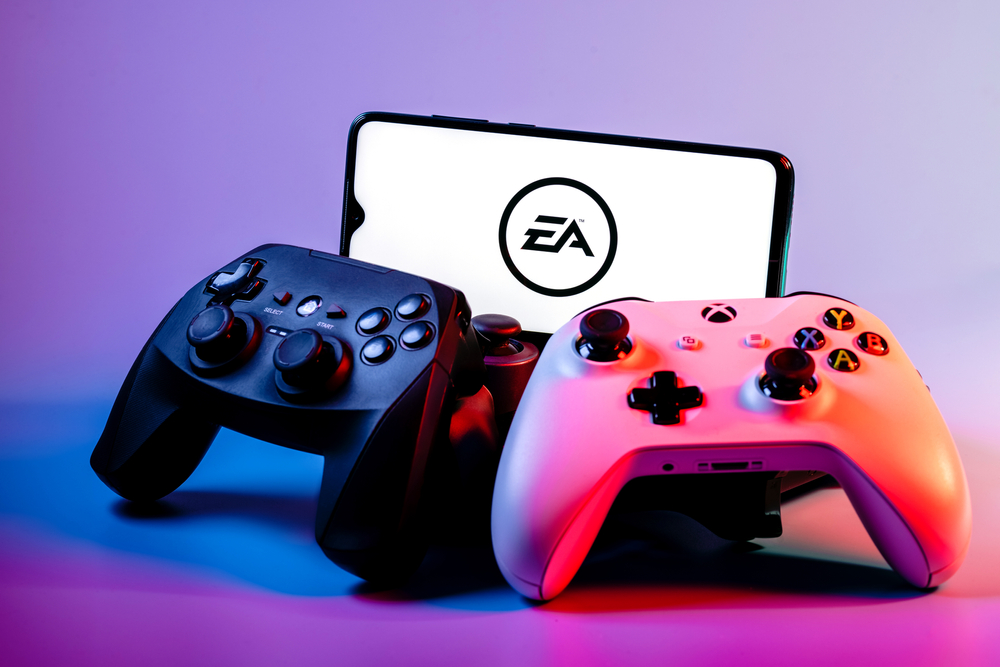 Communication Services - Electronic Arts, Inc_ gaming controllers by- Sergei Elagin via Shutterstock