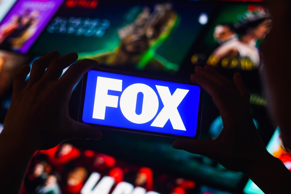 Communication Services - Fox Corporation media background by- rafapress via Shutterstock
