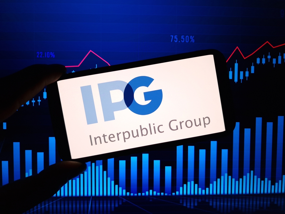 Communication Services - Interpublic Group Of Cos_, Inc_ logo with graph by- Piotr Swat via Shutterstock