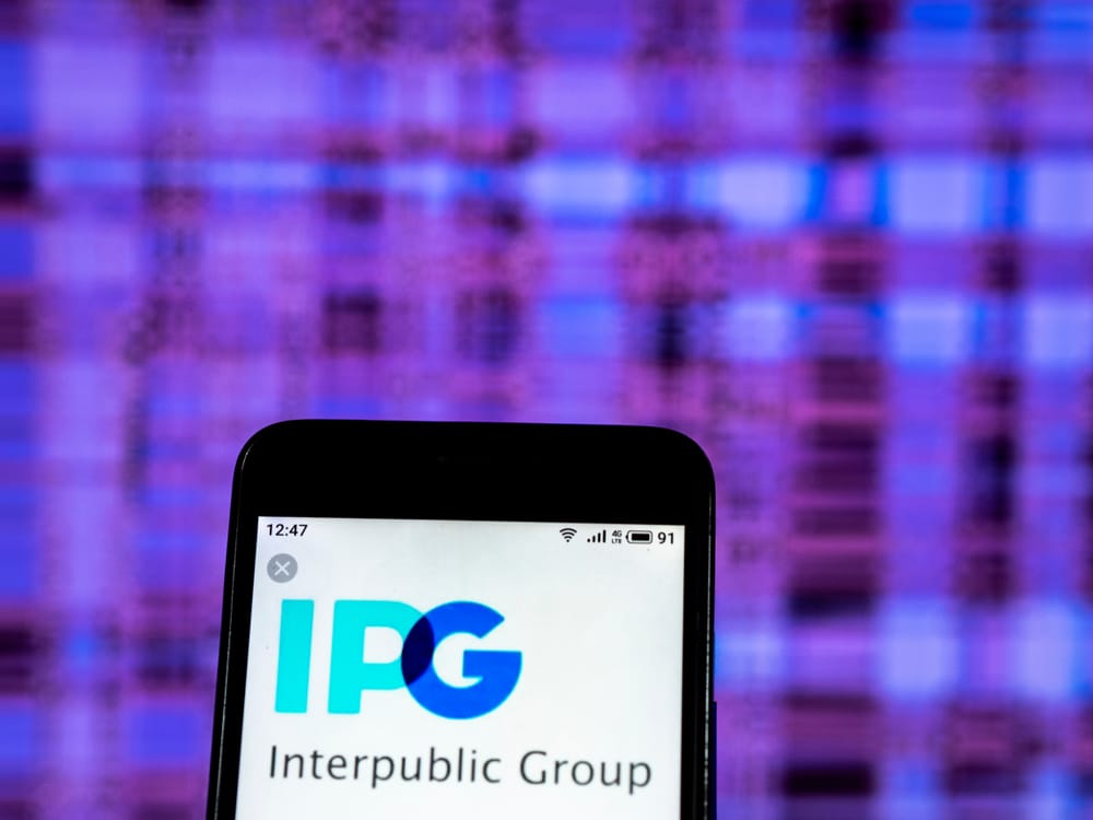 Interpublic Group Of Cos_, Inc_ phone with blue background by- IgorGolovniov via Shutterstock