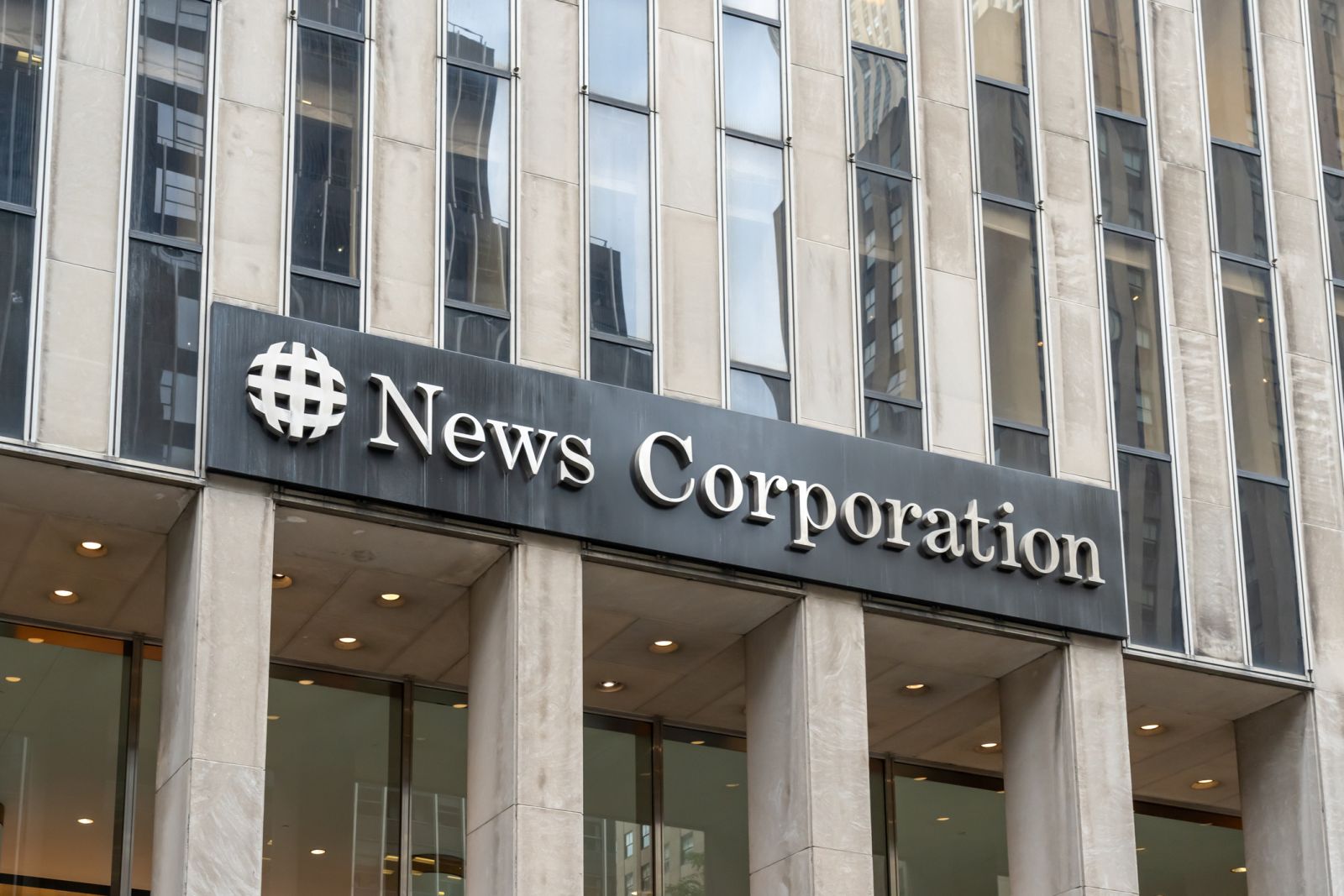 Communication Services - News Corp signage by- JHVEPhoto via iStock
