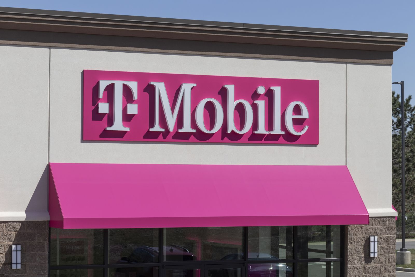 Communication Services - T-Mobile US Inc store signage by- jetcityimage via iStock