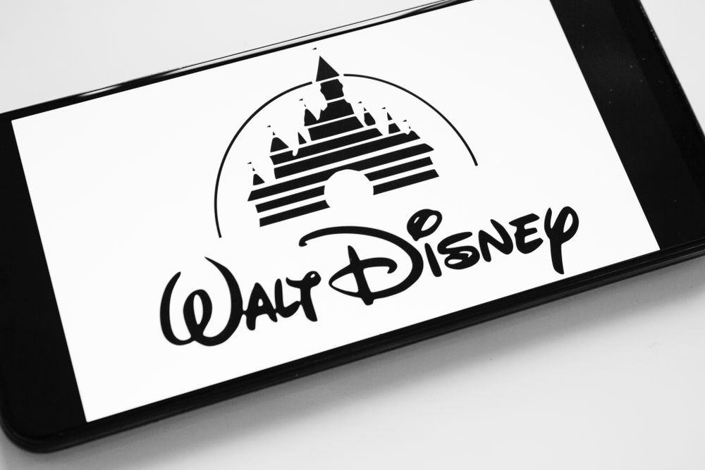Communication Services - Walt Disney Co logo on phone by- Allmy via Shutterstock