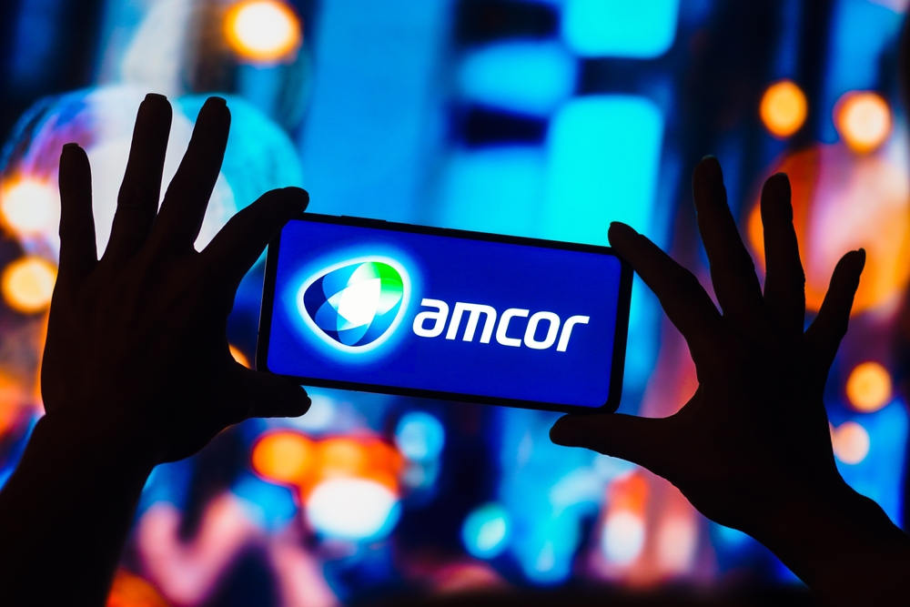 Consumer Cyclical (names A - H) - Amcor Plc phone in hands by- rafapress via Shutterstock