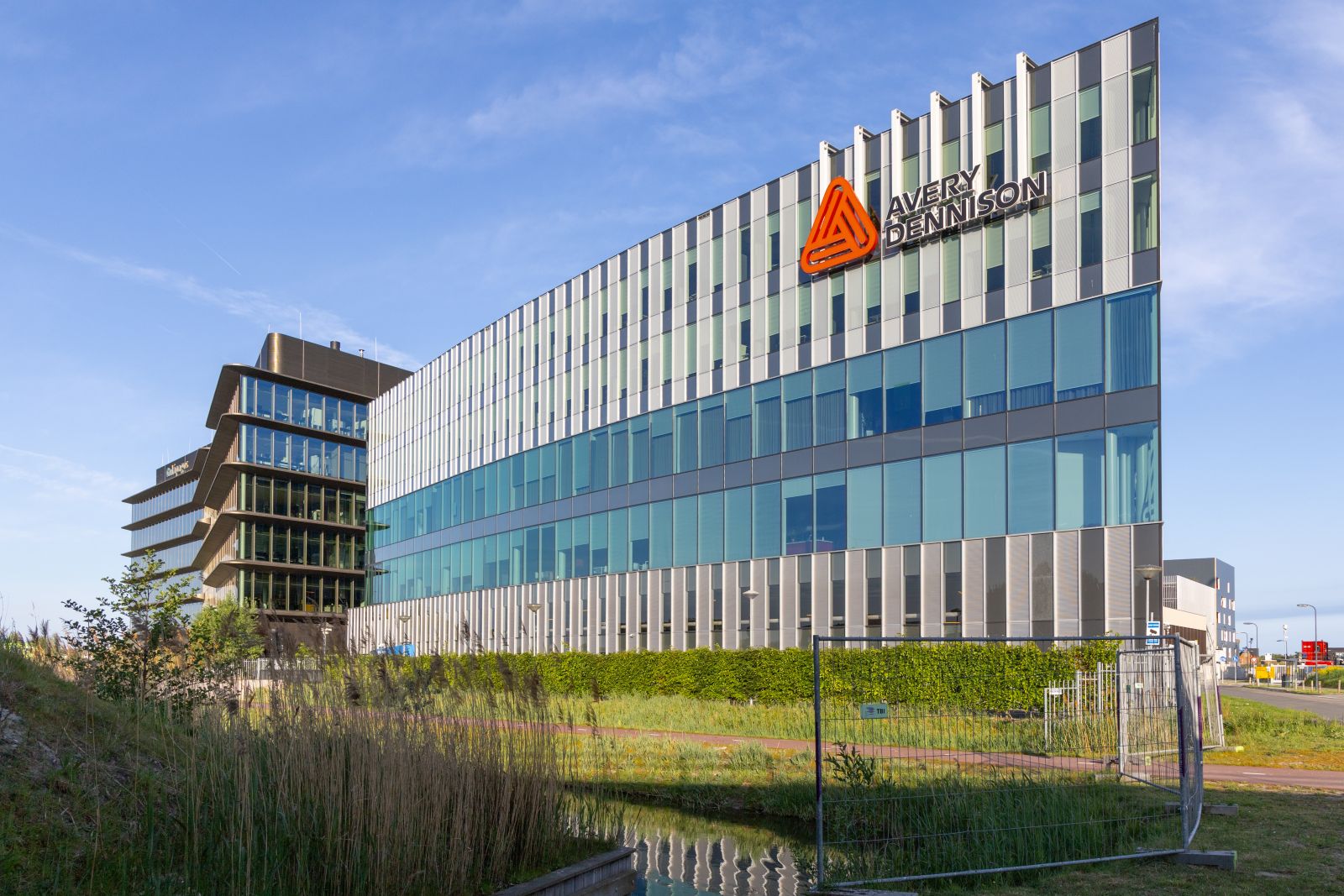 Avery Dennison European headquarters showcases sleek modern architecture with a reflective facade By PixelBiss