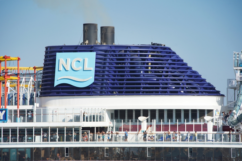 Consumer Cyclical (names I - Z) - Norwegian Cruise Line Holdings Ltd logo on ship by- Adam McCullough via Shutterstock