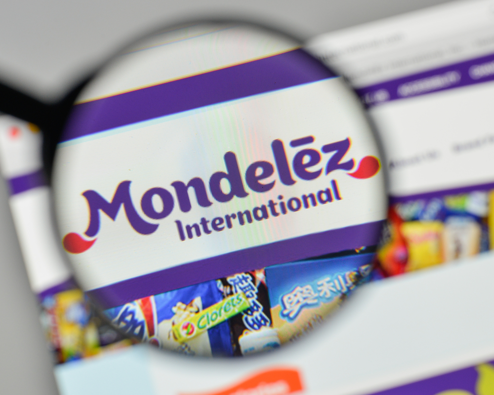 Consumer Defensive - Mondelez International Inc_ logo magnified- by CasimiroPT via Shutterstock