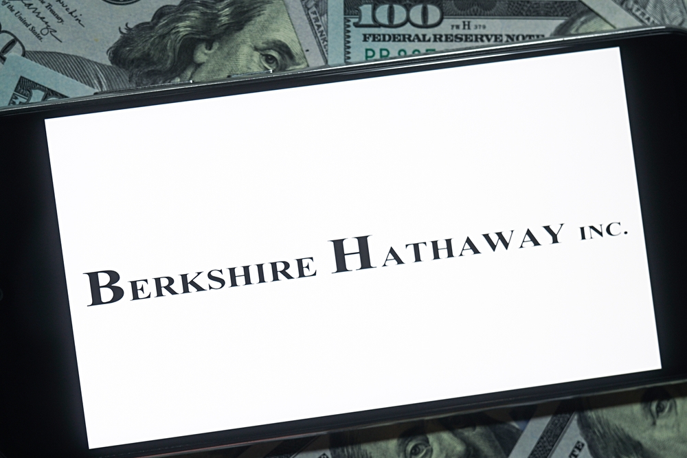 Financial (names A - I) - Berkshire Hathaway Inc_  logo and money background- by photo_gonzo via Shutterstock