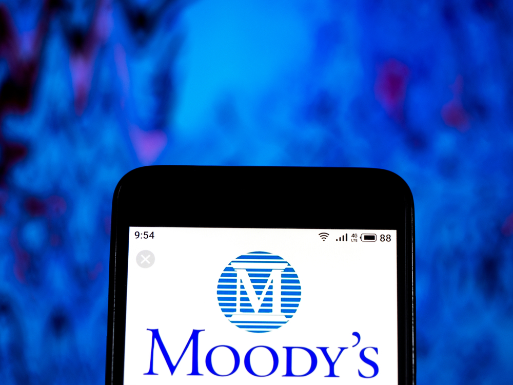 Moody's Corp_ phone with blue background-by IgorGolovniov via Shutterstock