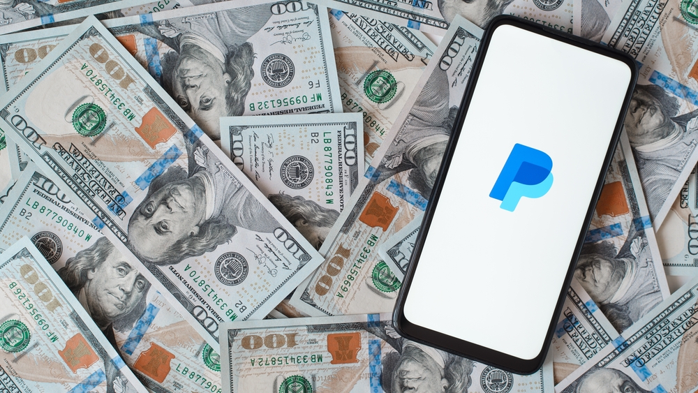 Financial (names J - Z) - PayPal Holdings Inc logo and money-by Sergio Photone via Shutterstock