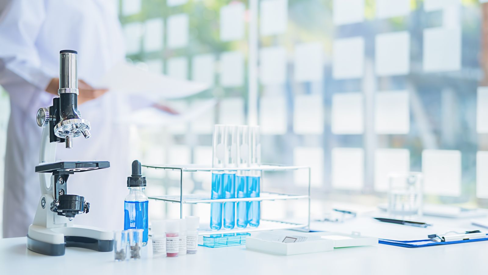 Doctor scientist looking at test tube solution by MIND AND I via Adobe Stock