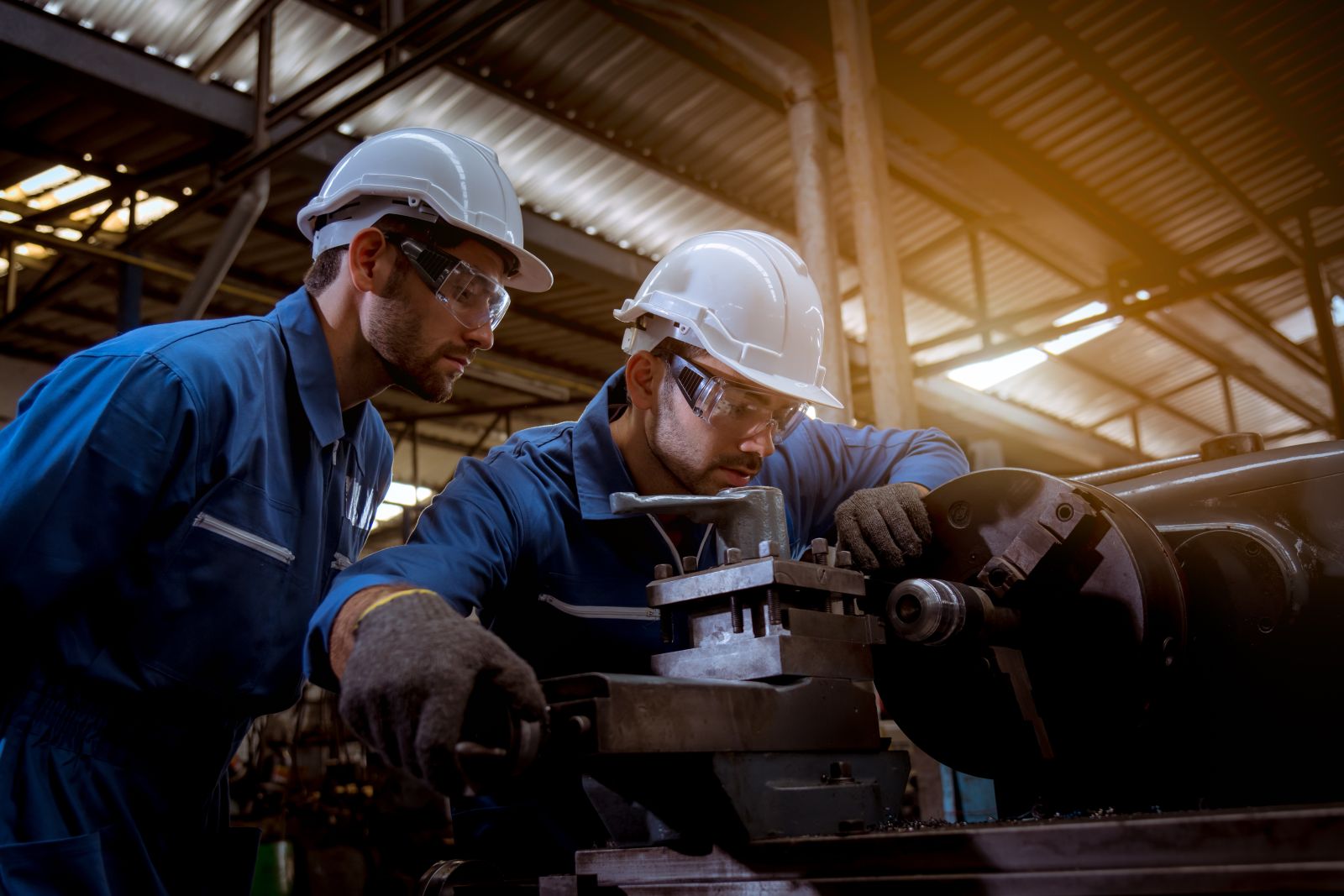 Industry engineer using safety uniform and vernier caliper in factory by APchanel via Adobe Stock