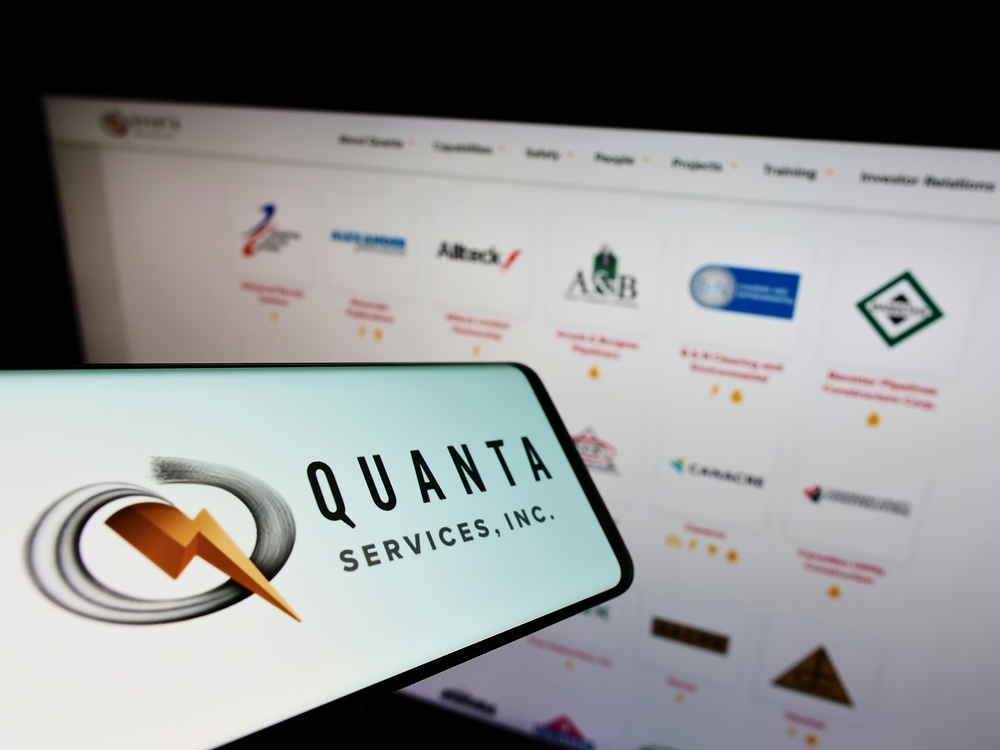 Industrials (names J - Z) - Quanta Services, Inc_ logo on phone and website-by T_Schneider via Shutterstock