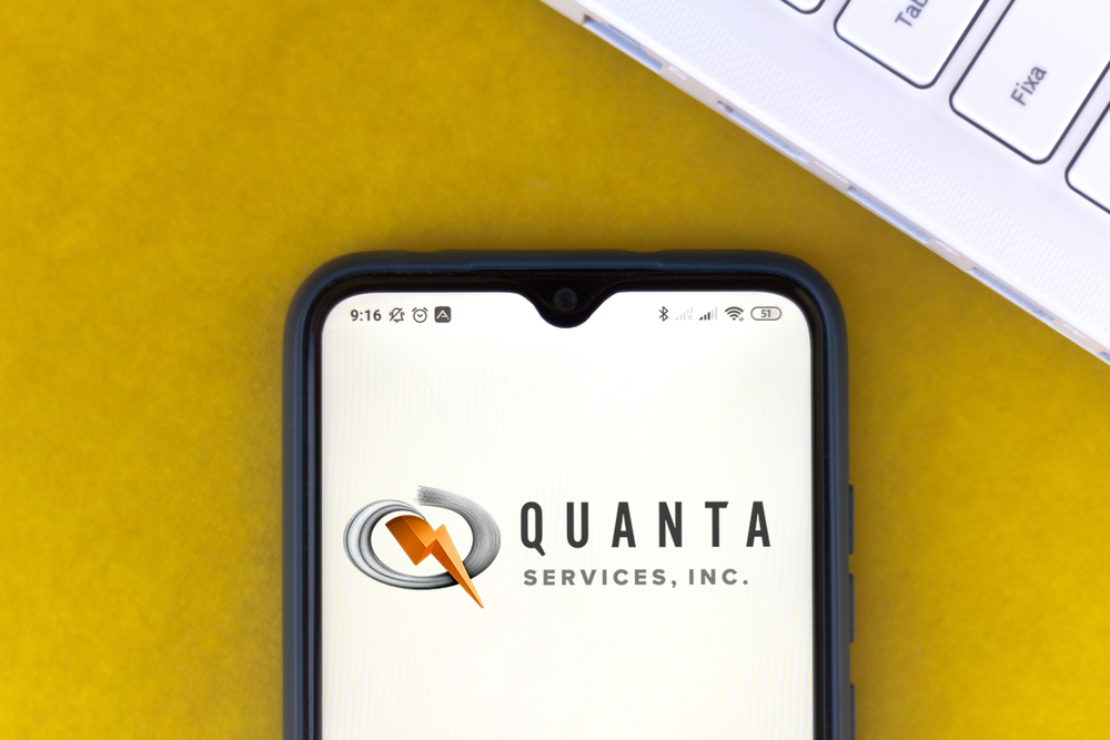 Industrials (names J - Z) - Quanta Services, Inc_ logo on phone-by rafapress via Shutterstock