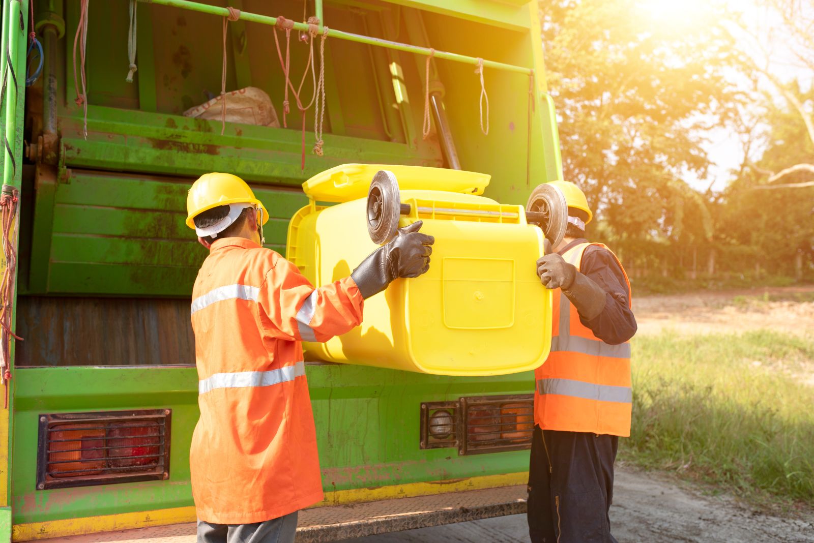 Workers emptying trash container garbage collection by somchai20162516 via Adobe Stock