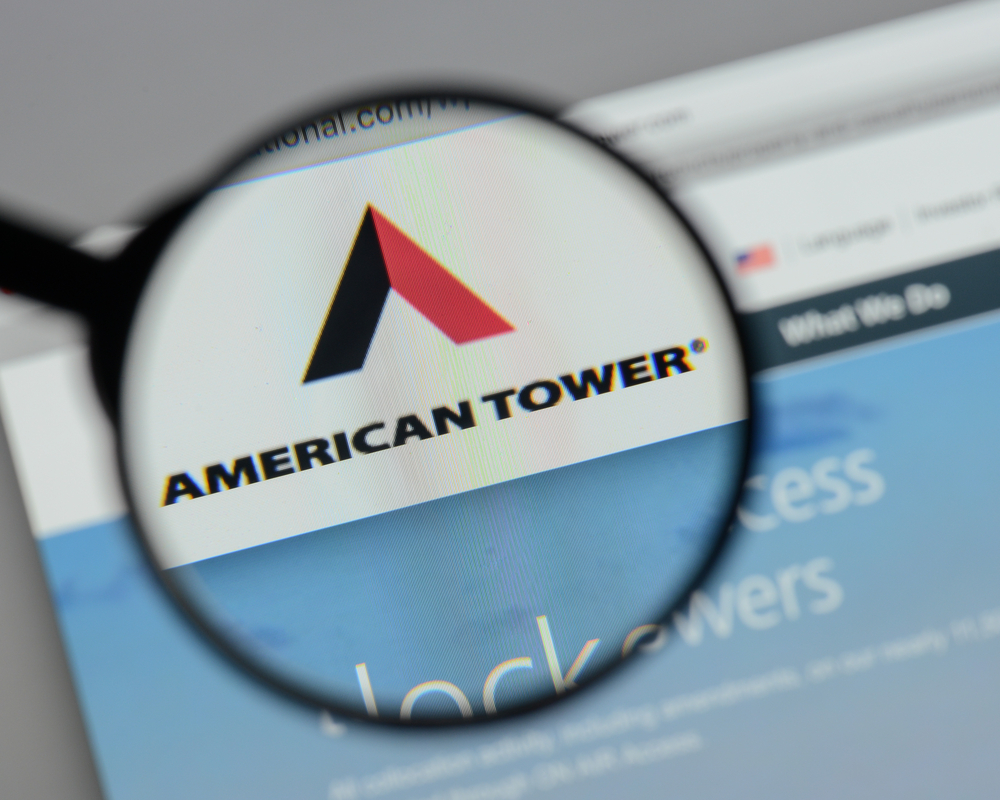 Real Estate - American Tower Corp_ magnified logo-by Casimiro PT via Shutterstock