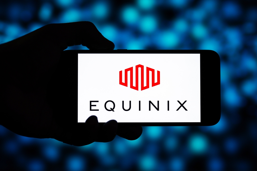 Real Estate - Equinix Inc logo on phone with blue background-by photo_gonzo via Shutterstock