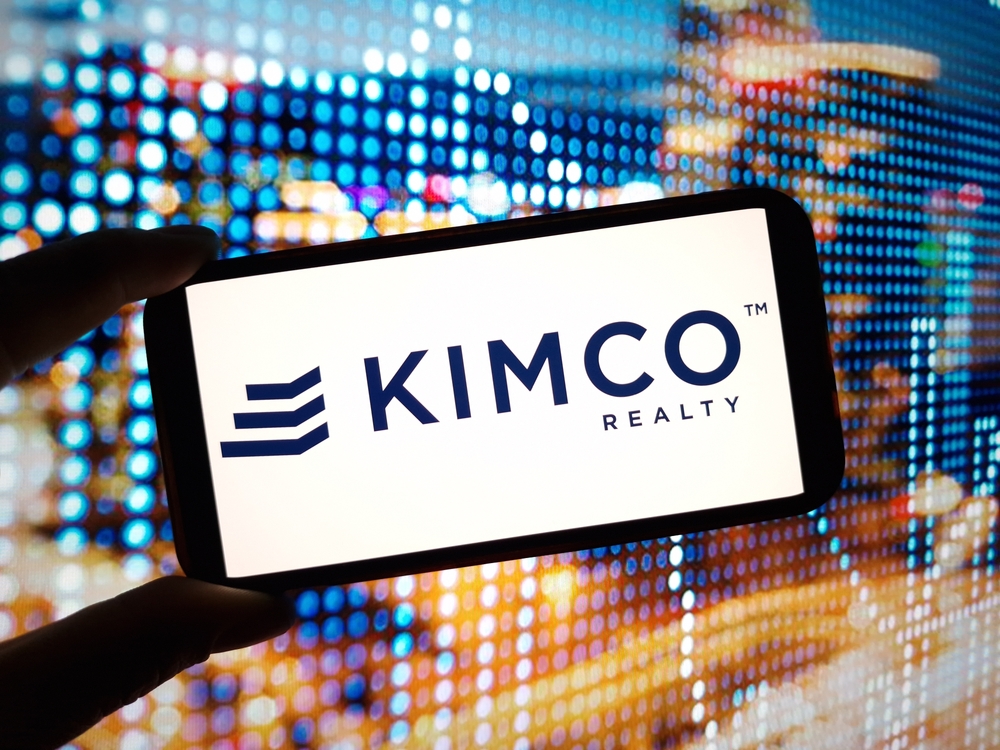 Real Estate - Kimco Realty Corporation logo on phone with lighted background-by Piotr Swat via Shutterstock