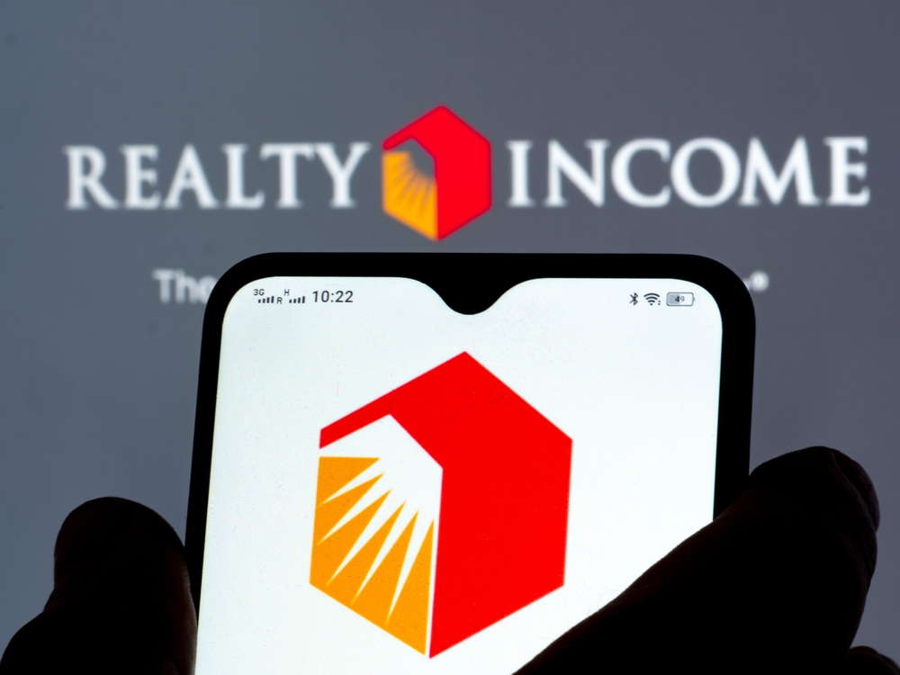 Real Estate - Realty Income Corp_ logo on smartphone-by IgorGolovniov via Shutterstock