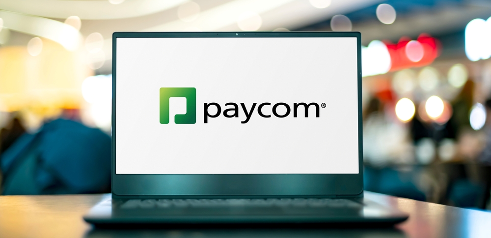 Technology (names J - Z) - Paycom Software Inc logo on laptop-by monticello via Shutterstock