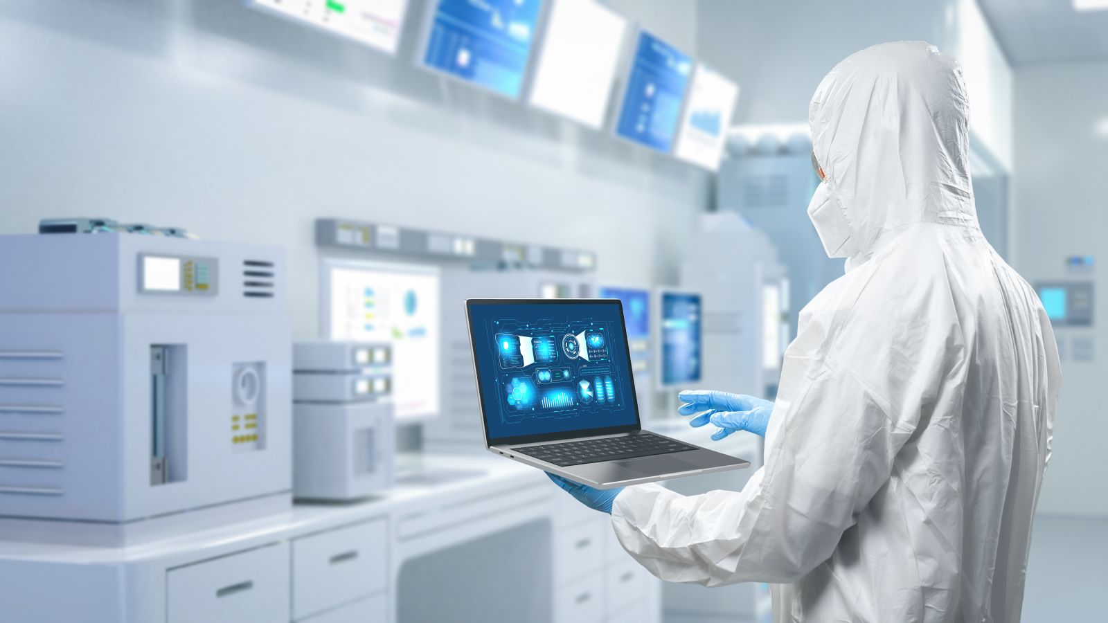 Worker in protective suit in semiconductor manufacturing factory by phonlamaiphoto via Adobe Stock