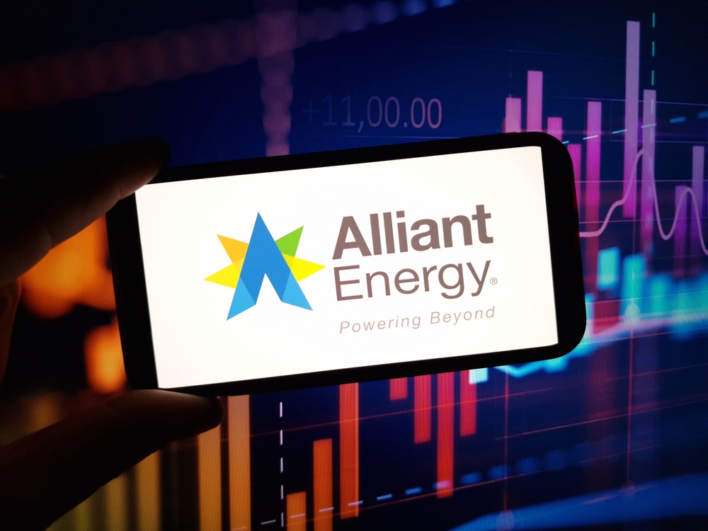 Utilities - Alliant Energy Corp_ logo on phone with stock background-by Piotr Swat via Shutterstock