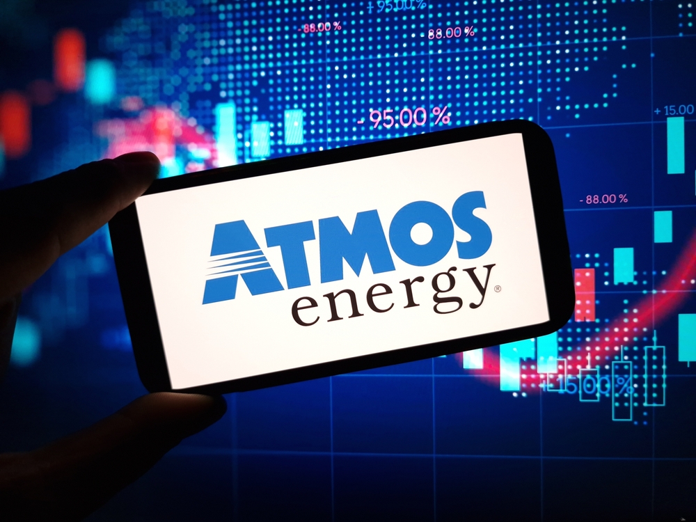 Utilities - Atmos Energy Corp_ logo on phone with chart-by Piotr Swat via Shutterstock