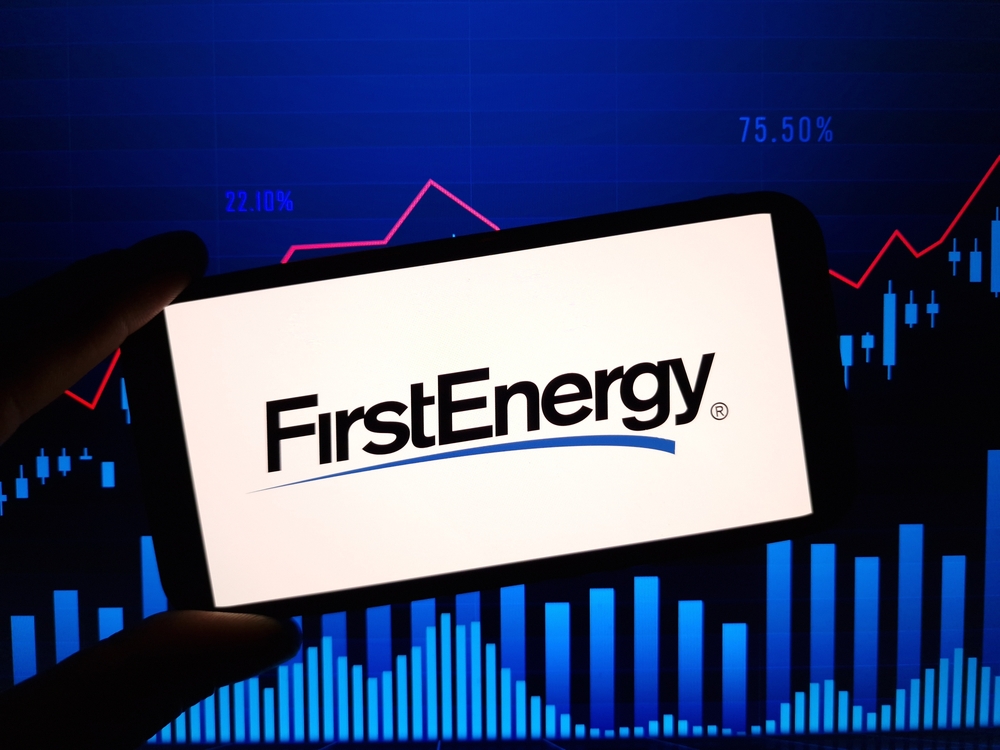 Utilities - Firstenergy Corp_ logo on phone and stock chart-by Piotr Swat via Shutterstock