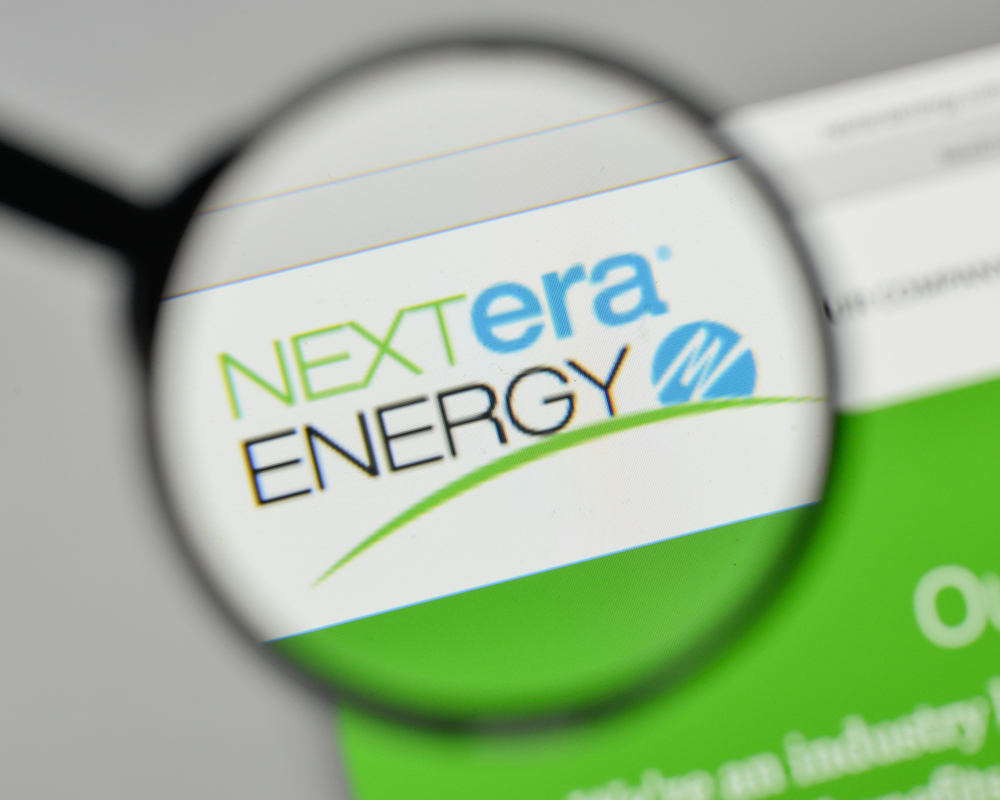 Utilities - NextEra Energy Inc logo magnified-by Casimiro PT via Shutterstock