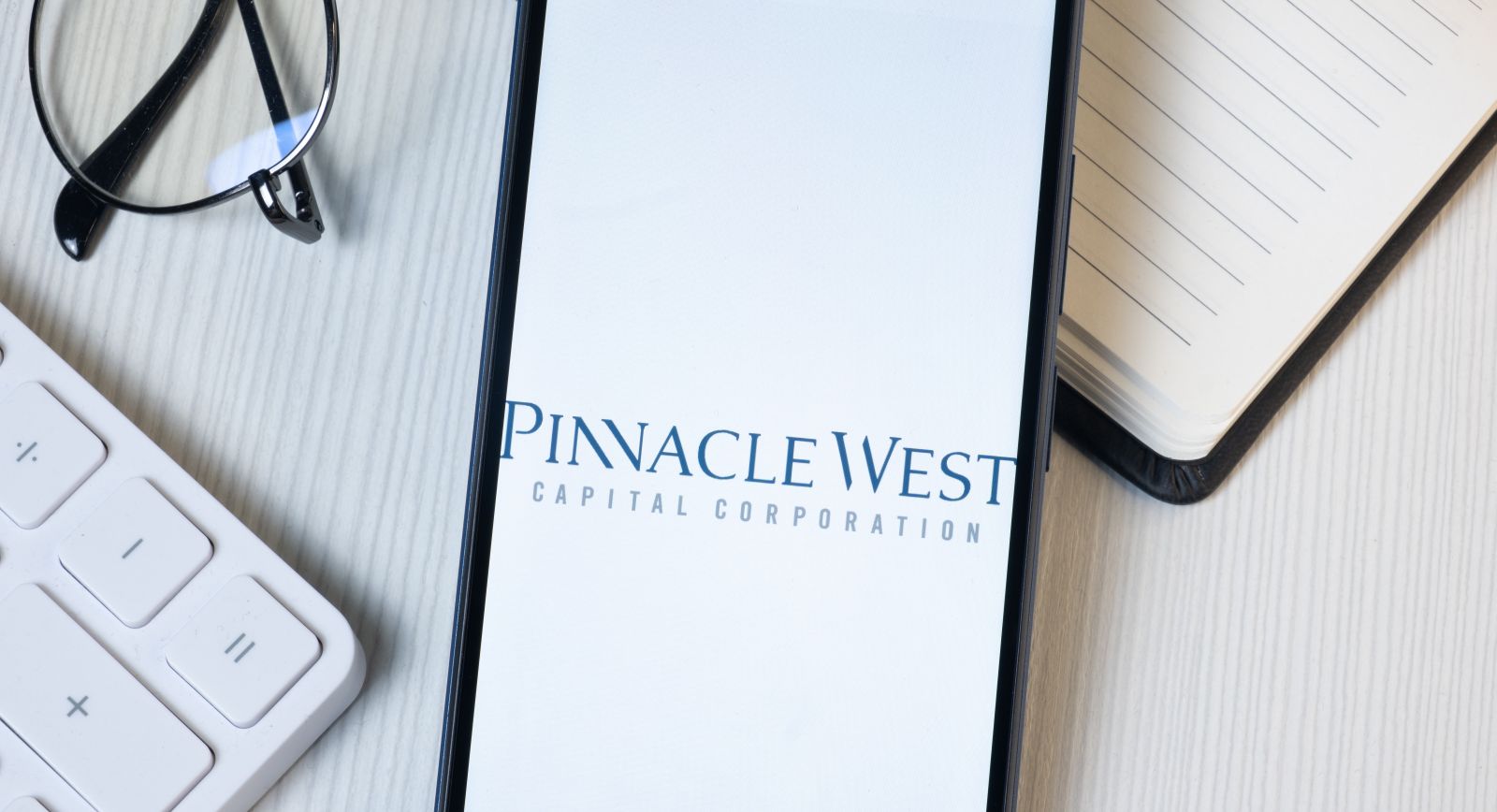 Pinnacle West Capital Logo on Phone Screen, Company Icon By Postmodern Studio