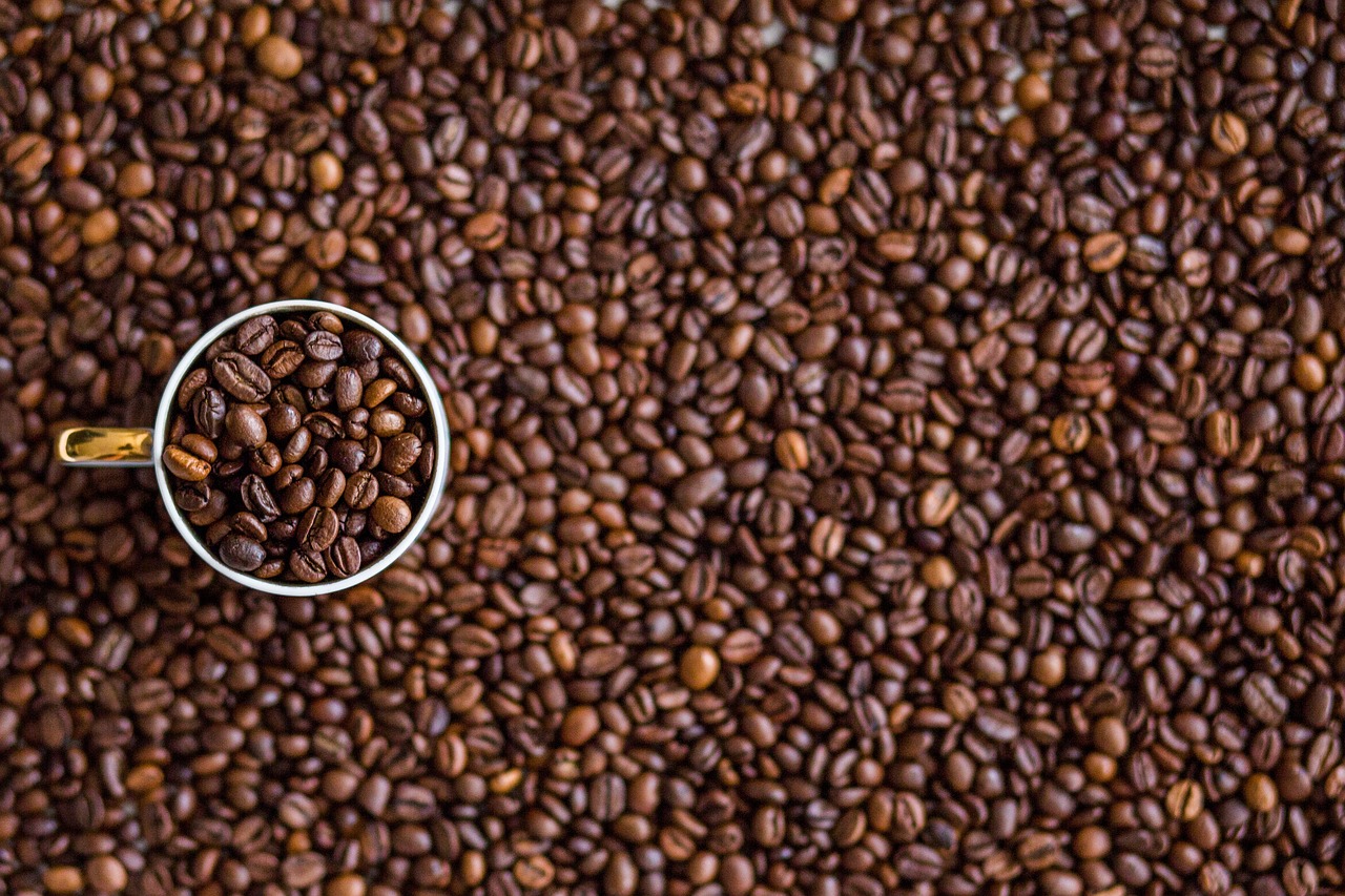 Cup of roasted coffee beans on pile by Negative-Space via Pixabay