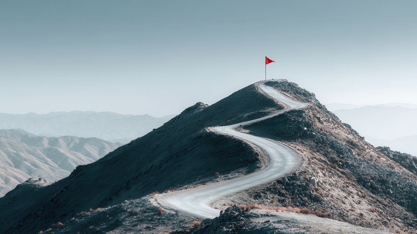 A red flag sitting atop a mountain by Stock by Hemal via Adobe Stock